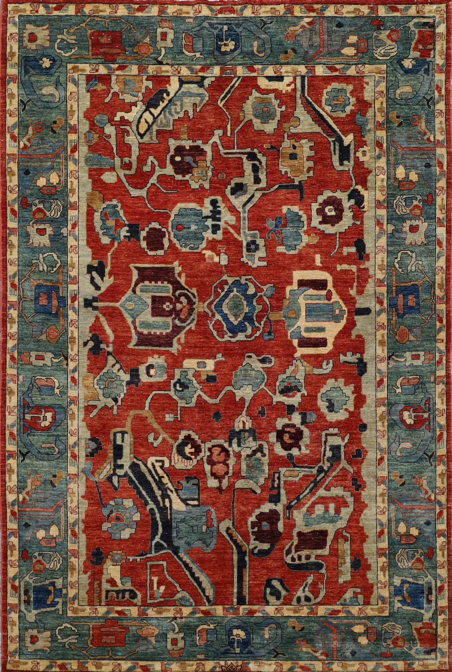 A traditional oriental-style area rug with a vibrant red central field, surrounded by a blue and beige patterned border. The rug features an intricate medallion and floral motif in shades of blue, cream, and brown.
